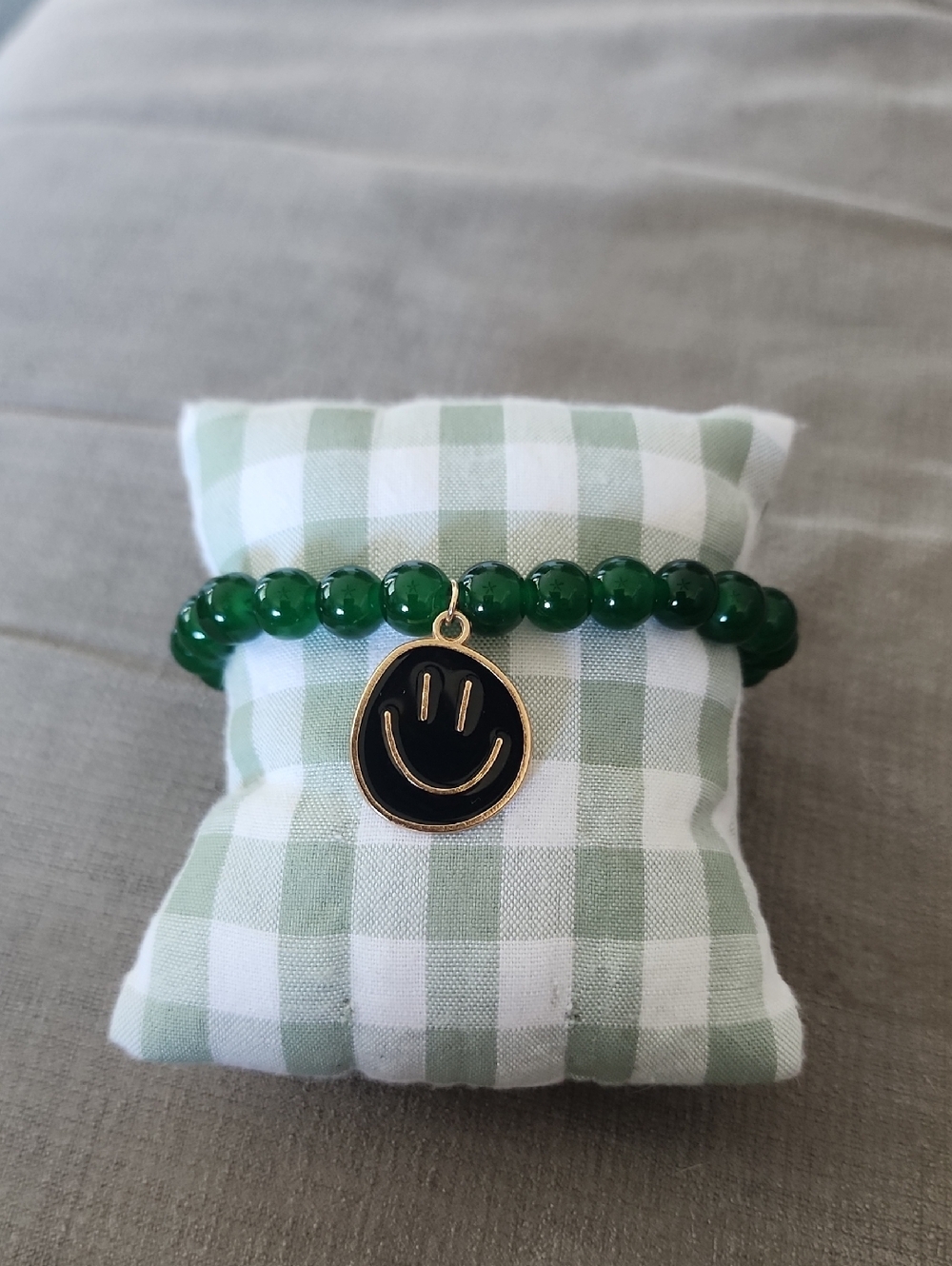 Green Beaded Bracelet with Black & Gold Smiley Charm